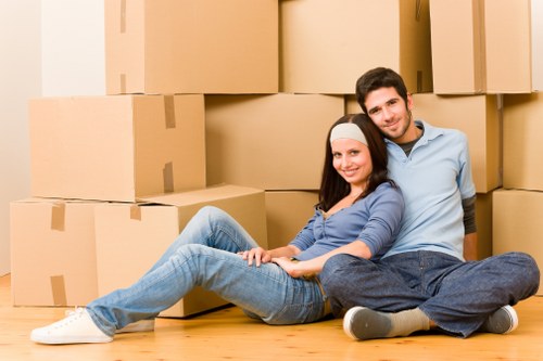 Team member handling moving boxes with gloves and careful lifting practice