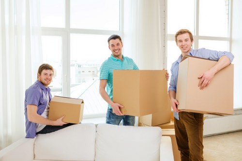 Professional movers carrying furniture through a residential property